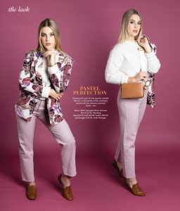 A blonde model wearing lilac pants, a white knit top and a print jacket.