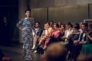 Anneliese Seubert | walking on the runway wearing a black and white Charly Thorn dress.